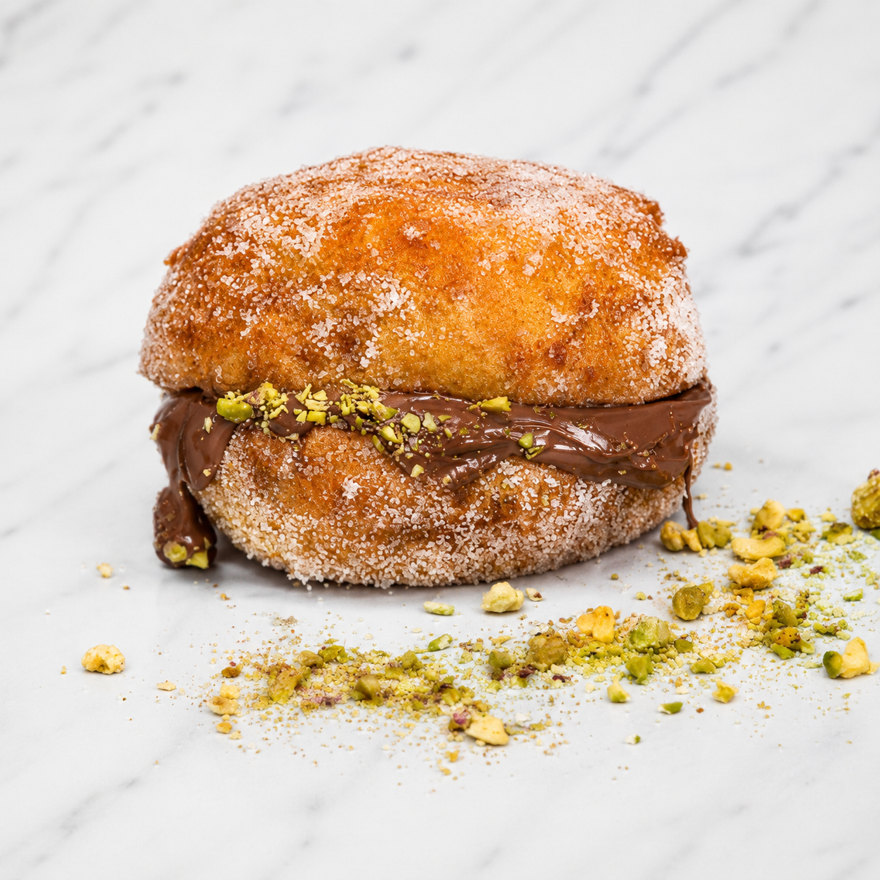 Macro shot of deep-fried Breagel with Nutella and pistachio